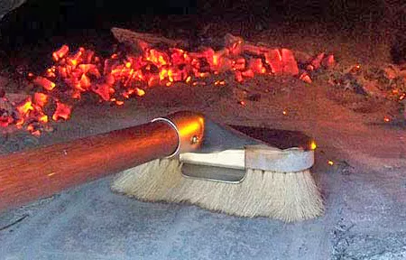 Brush tool used for cleaning the oven floor of a wood fired oven