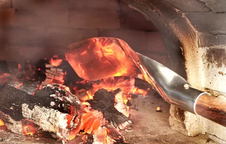 Coal scoop for managing hot coals in a wood fired oven