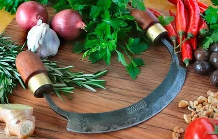 Mezzaluna, dough cutter and bread knife used for pizza and bread preparation