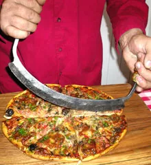 Cutting pizza with mezzaluna
